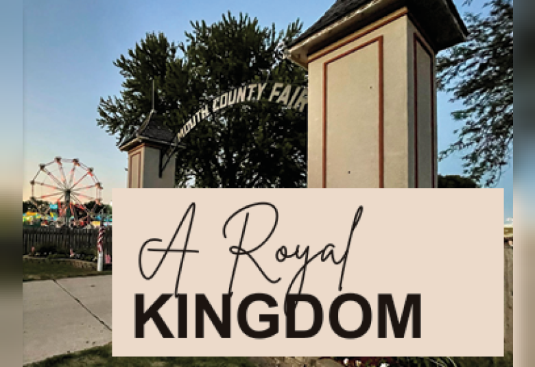 A far away shot of the Plymouth County Iowa Fair entrance gate, with the ferris wheel in the background. Over the photo are the words "A Royal Kingdom."
