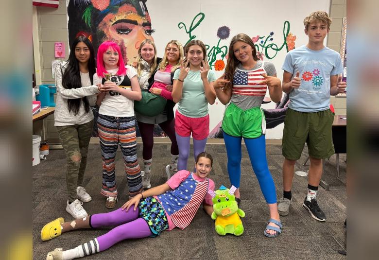 Pictured from left, Aundrea Oviedo, Peyton Hewitt, Suri Pierce, Isabella Utesch, Sophia Choquette, Talynn Kluender, Kevin Schoenfelder, and Bree Rolfes (front) take part in Scramble, or Mismatch Day, last Monday. (Photo courtesy of A-W School)